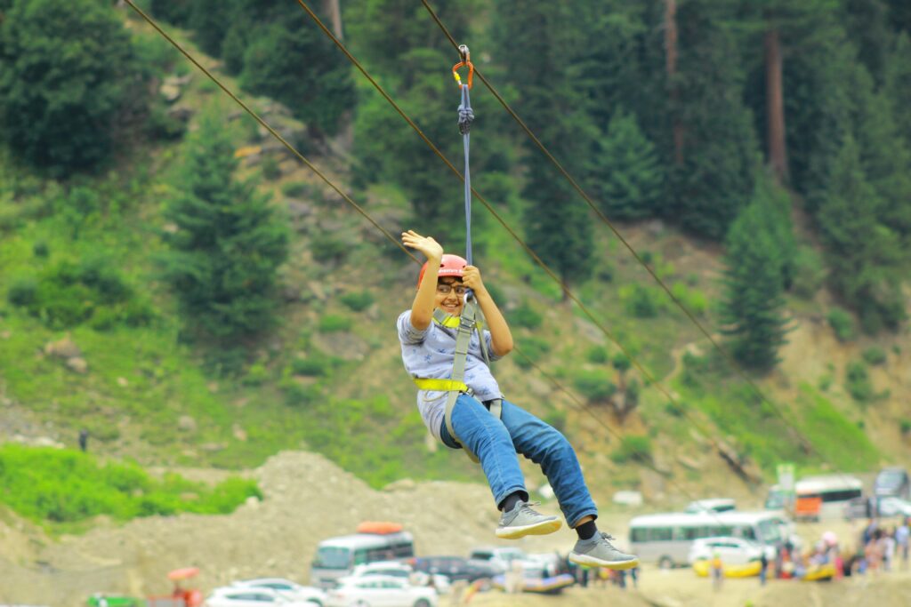 A thrilling zipline ride in scenic Naran, Pakistan, capturing joyful adventure.