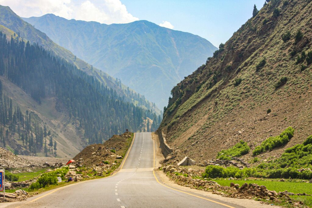 A stunning view of a highway cutting through the majestic mountain landscape in Pakistan, perfect for adventure travel.