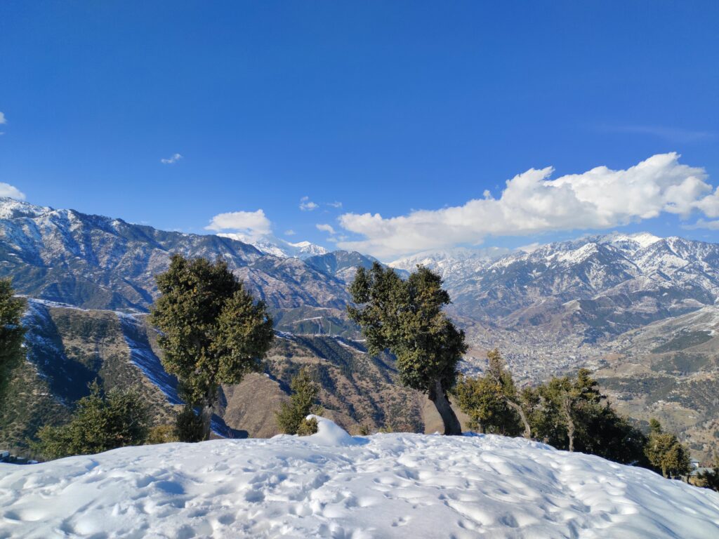 Breathtaking view of snow-covered mountains under a clear blue sky.